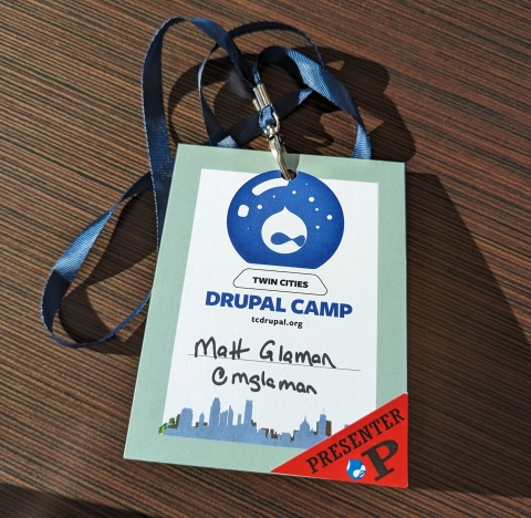Twin Cities DrupalCamp lanyard with "Matt Glaman" and handle "mglaman" written on it.